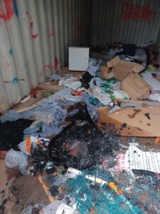 Container with rubbish, faeces and fire damage