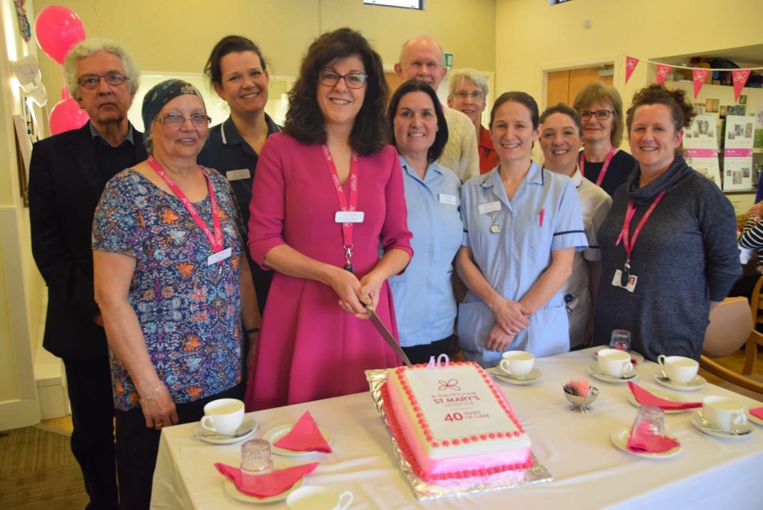 Birmingham St Mary's chief executive, Tina Swani, is invited to cut the cake at the 40th anniversary celebrations
