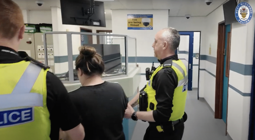 two officers and a suspect at Bournville lane custody suite